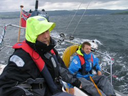 Keith concentrating at the tiller - Ben having a laugh.