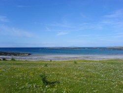 The Atlantic side of Tiree. The Outer Hebrides can just be seen in the distant background - some  25 miles away.